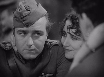 Movie still from “Hell's Angels” (1930), directed by Edmund Goulding – A man and a woman are looking at the camera; Close Up shot, Low angle
