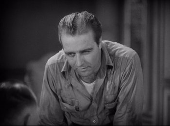 Movie still from “Hell's Angels” (1930), directed by Edmund Goulding – Black and white photograph of a man looking down; Close Up shot, Low angle