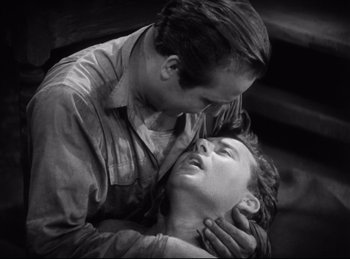 Movie still from “Hell's Angels” (1930), directed by Edmund Goulding – A man and a woman are kissing on the forehead; Close Up shot, High angle