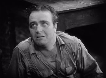 Movie still from “Hell's Angels” (1930), directed by Edmund Goulding – A man in a brown shirt is looking at the camera; Close Up shot, Low angle