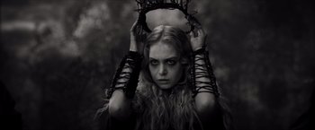 Movie still from “Hellboy” (2019), directed by Neil Marshall – A woman with long blonde curly hair holding a bunch of wires; Close Up shot, Low angle