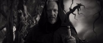 Movie still from “Hellboy” (2019), directed by Neil Marshall – A black and white photo of a man with a beard; Close Up shot, Low angle