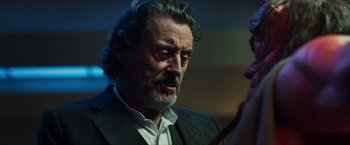 Movie still from “Hellboy” (2019), directed by Neil Marshall – A person wearing a suit and tie; Close Up shot, Over the shoulder angle