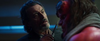 Movie still from “Hellboy” (2019), directed by Neil Marshall – A man holding a knife in front of a demon; Close Up shot, Over the shoulder angle