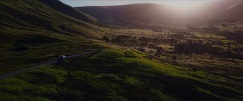 Movie still from “Hellboy” (2019), directed by Neil Marshall – A view of a valley with a road going through it; Extreme Wide shot, High angle