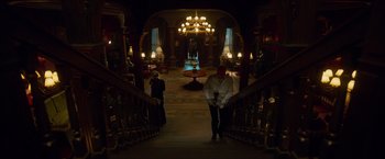 Movie still from “Hellboy” (2019), directed by Neil Marshall – A man standing on a staircase in a dark room; Extreme Wide shot, High angle