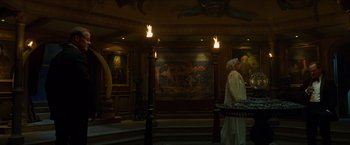 Movie still from “Hellboy” (2019), directed by Neil Marshall – A woman in a white dress and white fur hat; Wide shot, Low angle