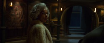Movie still from “Hellboy” (2019), directed by Neil Marshall – A woman in a white fur coat standing in a room; Close Up shot, Low angle