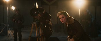 Movie still from “Hellboy” (2019), directed by Neil Marshall – A man and a woman are taking a picture; Medium shot, Low angle