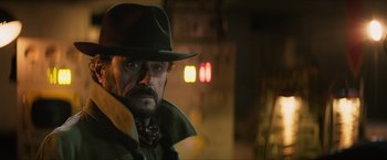 Movie still from “Hellboy” (2019), directed by Neil Marshall – A man in a hat and a coat and tie; Close Up shot, Over the shoulder angle