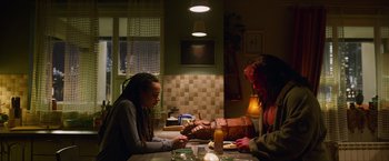 Movie still from “Hellboy” (2019), directed by Neil Marshall – Two people sitting at a table with food in front of them; Medium shot, High angle