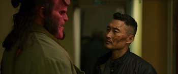 Movie still from “Hellboy” (2019), directed by Neil Marshall – A man in a black jacket and a man in a brown jacket and a man in a black jacket and a man in a brown jacket and a; Close Up shot, Over the shoulder angle