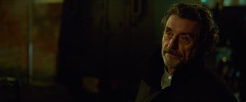 Movie still from “Hellboy” (2019), directed by Neil Marshall – An older man with a beard and a mustache; Close Up shot, Over the shoulder angle