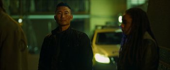 Movie still from “Hellboy” (2019), directed by Neil Marshall – A man standing in front of a yellow taxi cab at night; Close Up shot, Low angle