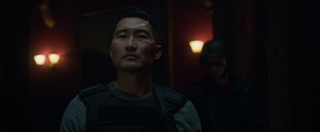 Movie still from “Hellboy” (2019), directed by Neil Marshall – A man with a knife in his face and a man with a helmet in the background; Close Up shot, Over the shoulder angle