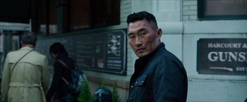 Movie still from “Hellboy” (2019), directed by Neil Marshall – A person wearing a black jacket; Close Up shot, Over the shoulder angle