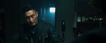 Movie still from “Hellboy” (2019), directed by Neil Marshall – A person holding a pool cue; Close Up shot, Over the shoulder angle