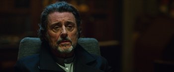 Movie still from “Hellboy” (2019), directed by Neil Marshall – A person sitting in a chair; Close Up shot, Over the shoulder angle