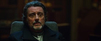 Movie still from “Hellboy” (2019), directed by Neil Marshall – A person sitting in a chair; Close Up shot, Over the shoulder angle