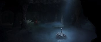 Movie still from “Hellboy” (2019), directed by Neil Marshall – A rock in the middle of a pool of water near a body of water; Extreme Wide shot, High angle