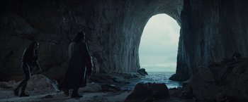 Movie still from “Hellboy” (2019), directed by Neil Marshall – A person standing in front of a cave; Extreme Wide shot, Low angle
