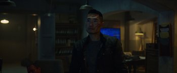 Movie still from “Hellboy” (2019), directed by Neil Marshall – A man in a dark room looking at the camera; Close Up shot, Over the shoulder angle