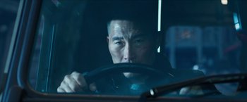 Movie still from “Hellboy” (2019), directed by Neil Marshall – A man driving a car at night in the dark; Close Up shot, Over the shoulder angle