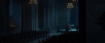 Movie still from “Hellboy” (2019), directed by Neil Marshall – Two people are sitting in a dark room; Extreme Wide shot, High angle