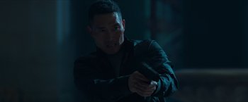 Movie still from “Hellboy” (2019), directed by Neil Marshall – A man holding a cell phone while wearing a black jacket; Close Up shot, Low angle