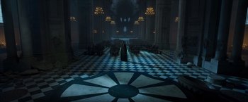 Movie still from “Hellboy” (2019), directed by Neil Marshall – A person standing in front of an audience in a dark room; Extreme Wide shot, High angle