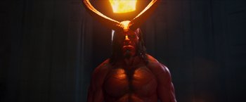 Movie still from “Hellboy” (2019), directed by Neil Marshall – A man with a red body and horns on his head; Medium shot, Over the shoulder angle