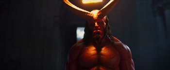 Movie still from “Hellboy” (2019), directed by Neil Marshall – A person wearing a costume with horns; Medium shot, Over the shoulder angle