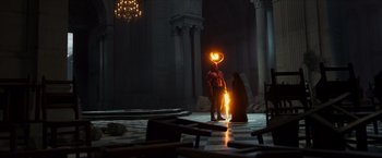 Movie still from “Hellboy” (2019), directed by Neil Marshall – A man standing next to a woman holding a fire ring; Wide shot, High angle