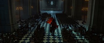 Movie still from “Hellboy” (2019), directed by Neil Marshall – A man in a red jacket is walking through a room; Extreme Wide shot, High angle