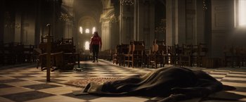 Movie still from “Hellboy” (2019), directed by Neil Marshall – A woman in a red jacket walking down the aisle of a church; Extreme Wide shot, High angle