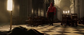 Movie still from “Hellboy” (2019), directed by Neil Marshall – A man with a red mask standing in a room; Wide shot, Over the shoulder angle