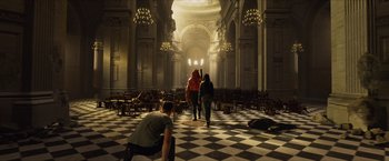 Movie still from “Hellboy” (2019), directed by Neil Marshall – Three people are walking in a large room; Extreme Wide shot, High angle