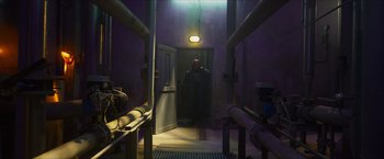 Movie still from “Hellboy” (2019), directed by Neil Marshall – A man standing in a doorway of a building; Wide shot, Low angle