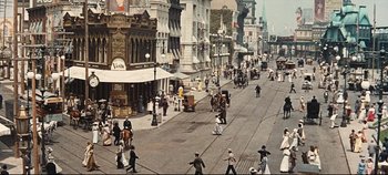Movie still from “Hello, Dolly!” (1969), directed by Gene Kelly – An old photo of people walking down the street; Extreme Wide shot, High angle