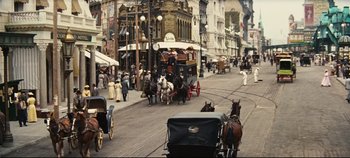 Movie still from “Hello, Dolly!” (1969), directed by Gene Kelly – Horse drawn carriages on a city street; Extreme Wide shot, High angle
