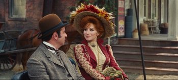 Movie still from “Hello, Dolly!” (1969), directed by Gene Kelly – A man and a woman dressed in victorian clothing; Medium shot, Over the shoulder angle