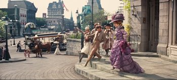 Movie still from “Hello, Dolly!” (1969), directed by Gene Kelly – A group of people dressed in period clothing on a street; Wide shot, High angle