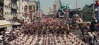 Movie still from “Hello, Dolly!” (1969), directed by Gene Kelly – A parade with a lot of people on horses; Extreme Wide shot, High angle
