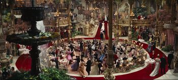 Movie still from “Hello, Dolly!” (1969), directed by Gene Kelly – A group of people in formal wear dancing in a ballroom; Extreme Wide shot, High angle