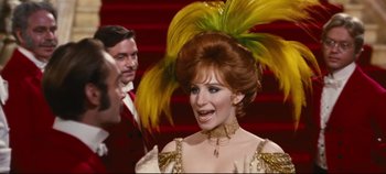 Movie still from “Hello, Dolly!” (1969), directed by Gene Kelly – A person wearing a costume; Medium shot, Over the shoulder angle