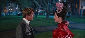 Movie still from “Hello, Dolly!” (1969), directed by Gene Kelly – A man and a woman standing next to each other; Medium shot, Over the shoulder angle