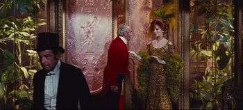 Movie still from “Hello, Dolly!” (1969), directed by Gene Kelly – A man and a woman dressed up in fancy costumes; Medium shot, Over the shoulder angle