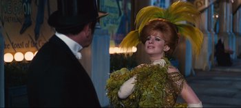 Movie still from “Hello, Dolly!” (1969), directed by Gene Kelly – A man and a woman dressed up in costumes; Medium shot, Over the shoulder angle