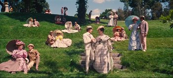 Movie still from “Hello, Dolly!” (1969), directed by Gene Kelly – A man and a woman dressed in old fashion clothing; Extreme Wide shot, High angle