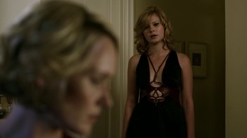 Movie still from “Hellraiser: Revelations” (2011), directed by Víctor Garcia – A woman in a black dress standing in front of a mirror; Medium shot, Over the shoulder angle